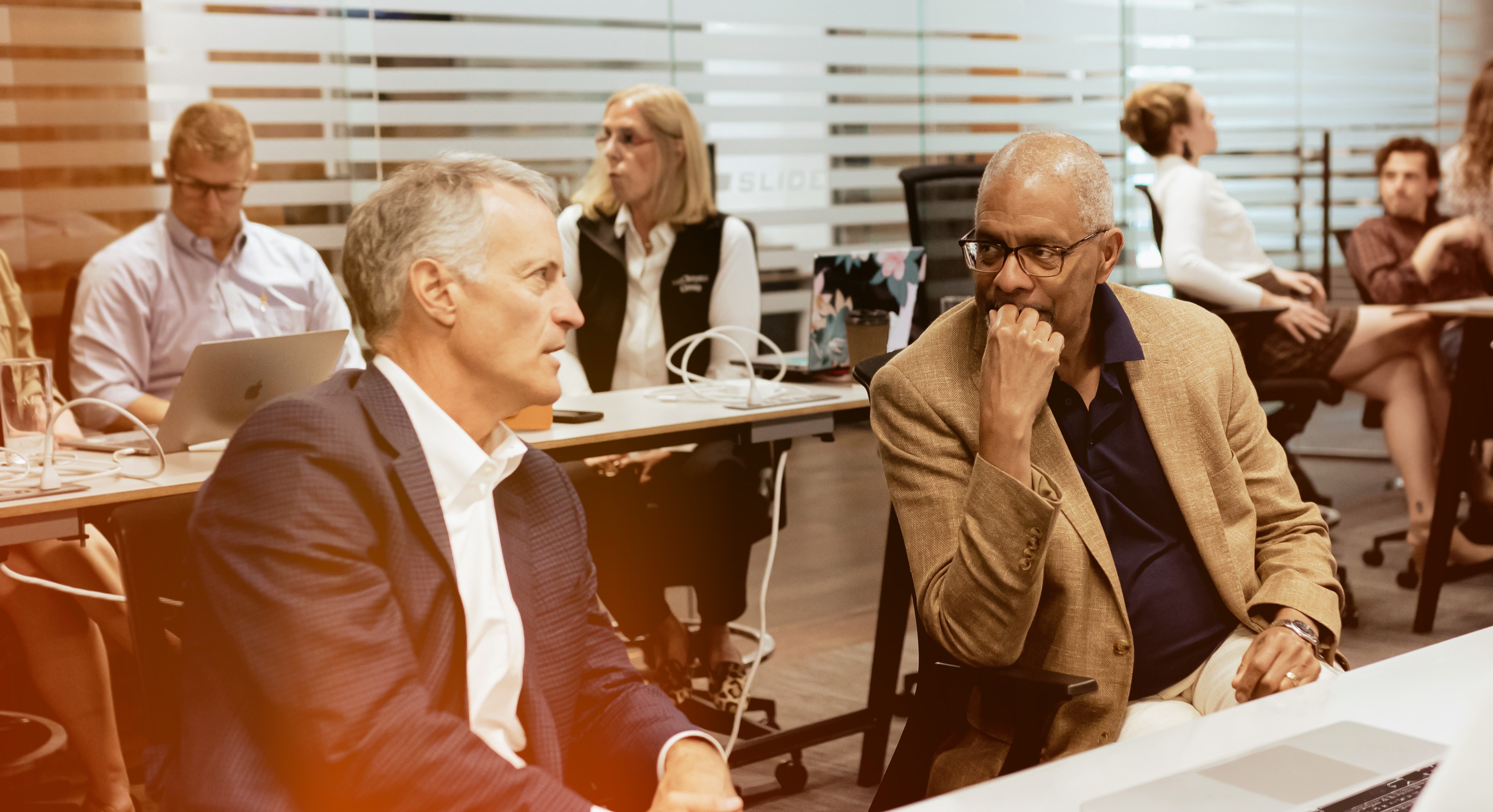 Employees in Conversation Sitting at Tables