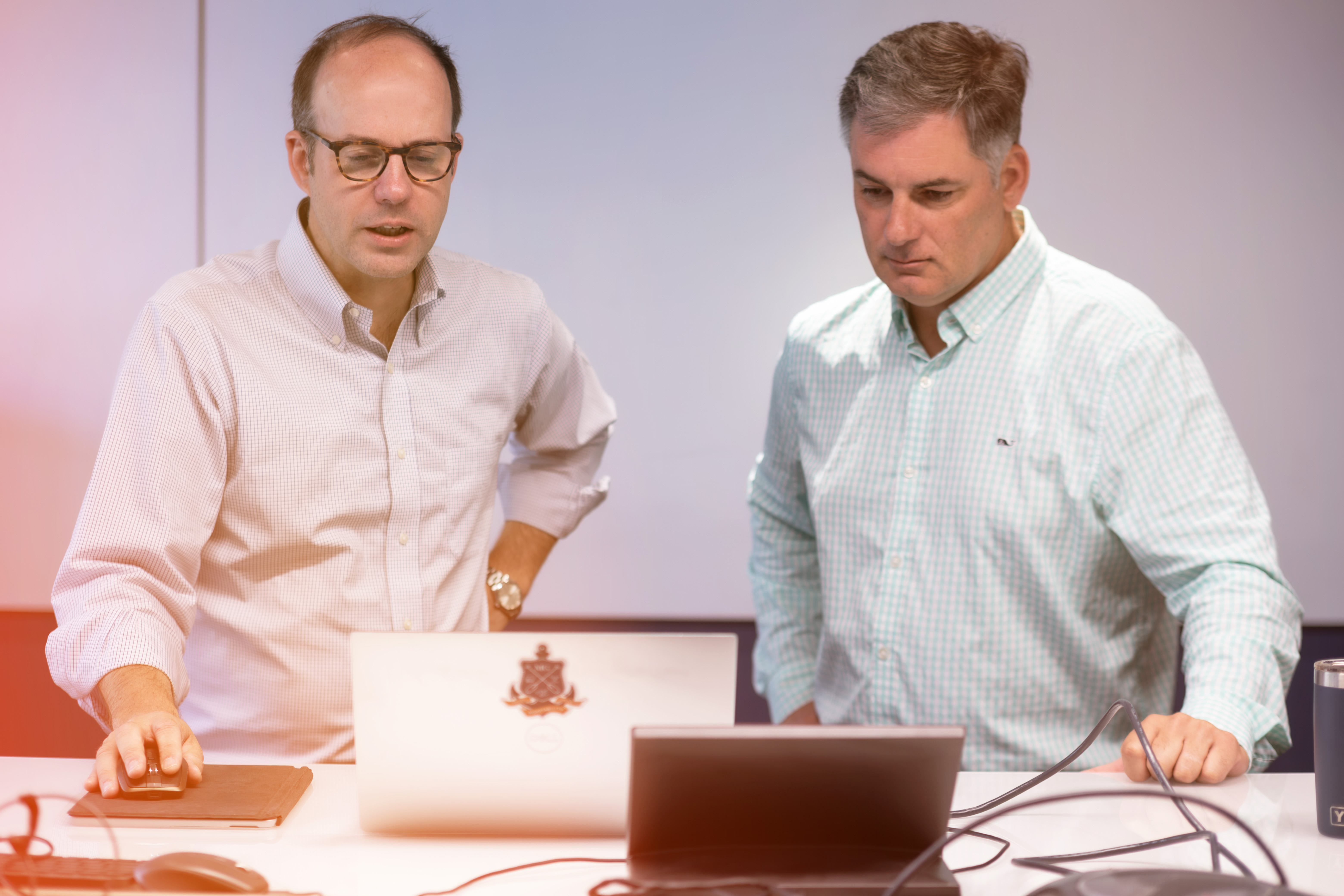 Two men collaborating on a computer